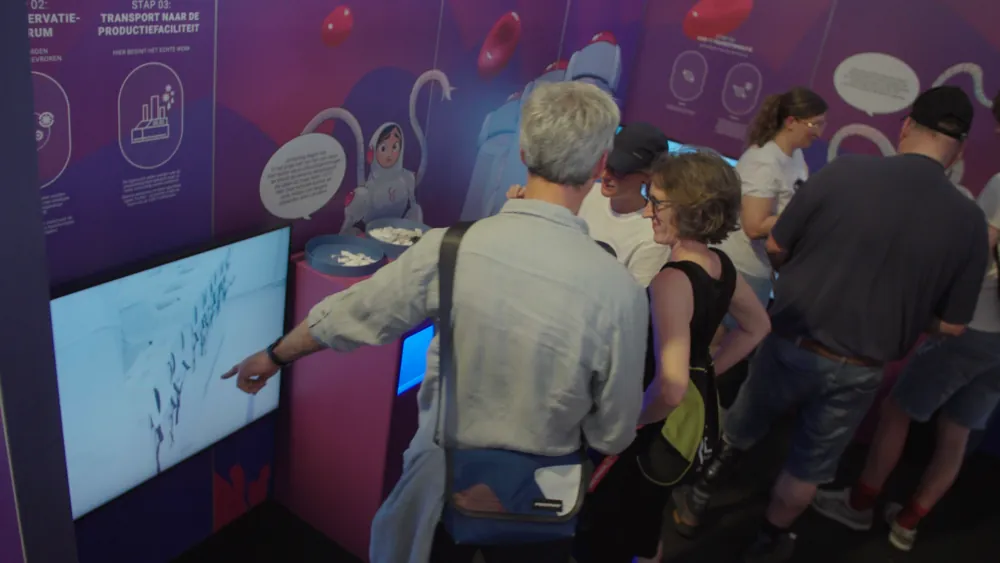 Visitors at a booth screen during the Showcase Experience