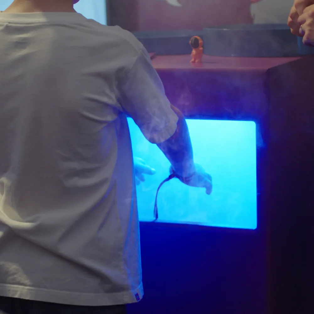 A visitor trying one of the assignment stations on the booth