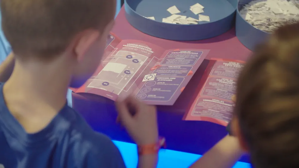 Visitors at the sticker station with the open stickerbook