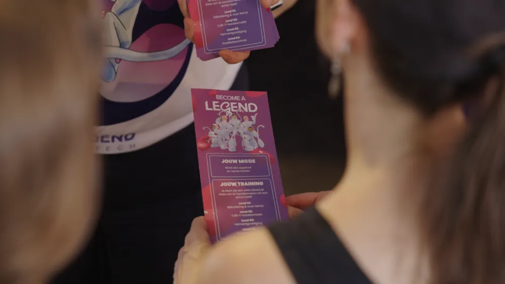 A visitor holding the Become a Legend stickerbook